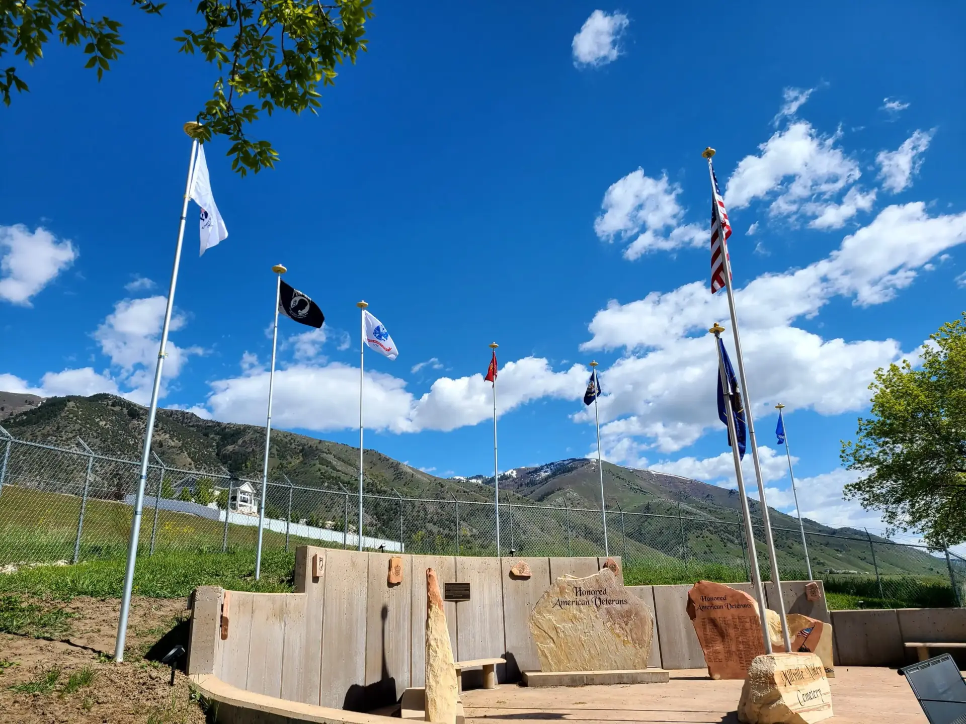 Flags flying against a mountainous backdrop.